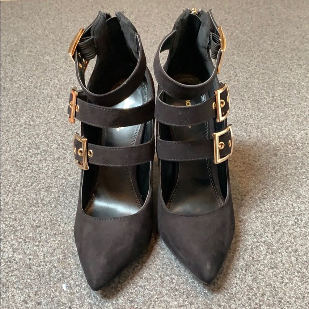 Black suede heels with gold buckles